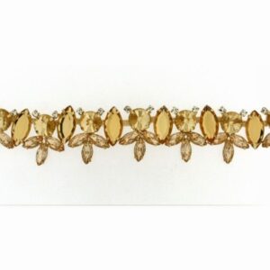 (513)accessorio colore oro con anelle laterali, castoni e pietre colore topazio e crystal. lughezza totale cm 20, 5 circa.